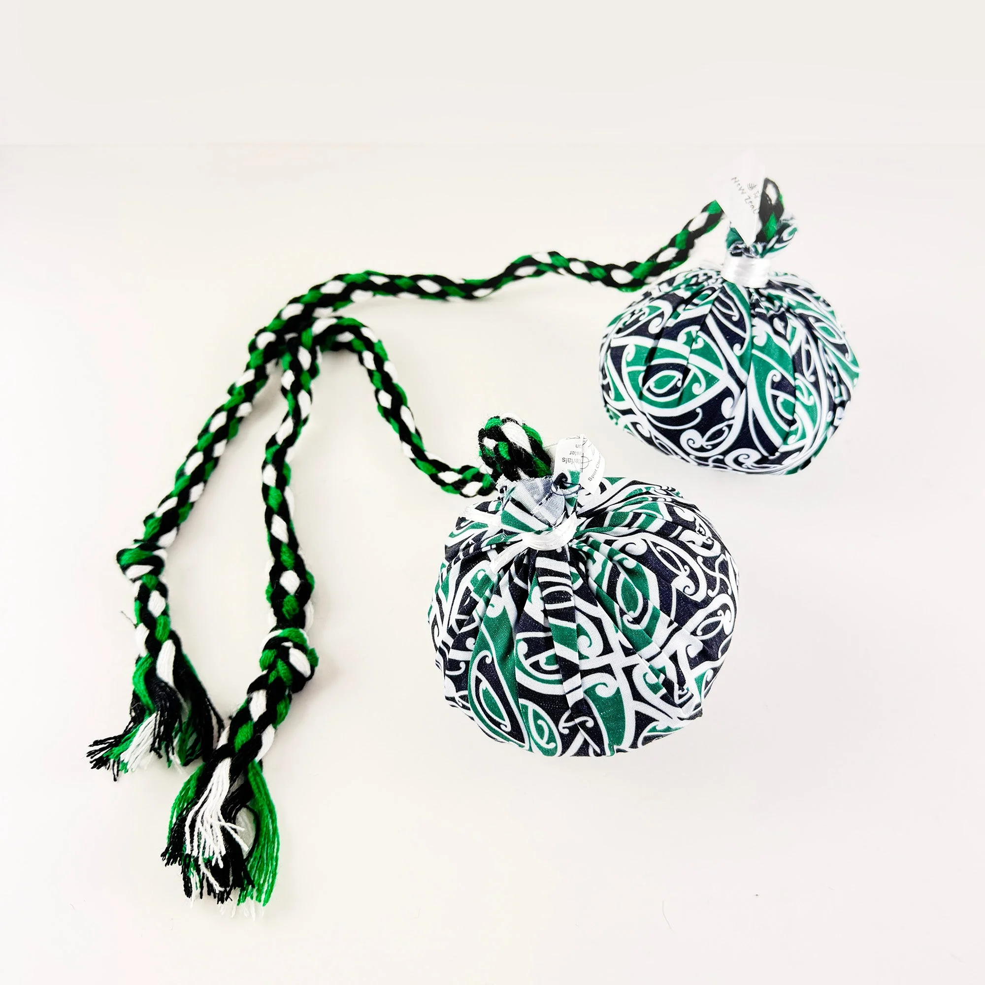 Set of Māori Poi with Green White and Black Patterned Cover