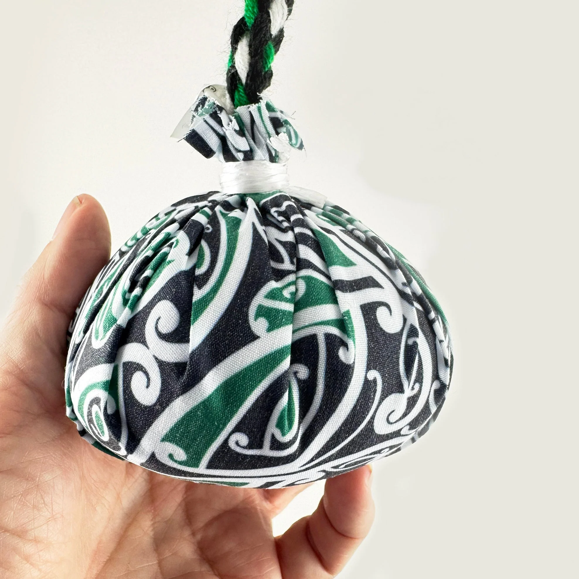 Set of Māori Poi with Green White and Black Patterned Cover - Image 3